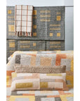 Shale Hand Woven Pastel Color Large Geometric Lumbar Pillow displayed with matching woven blanket and textured decor.