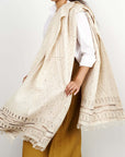 Unah Brown Fully Hand Embroidered Throw Handloom Organic Cotton Throw draped gracefully by a model.