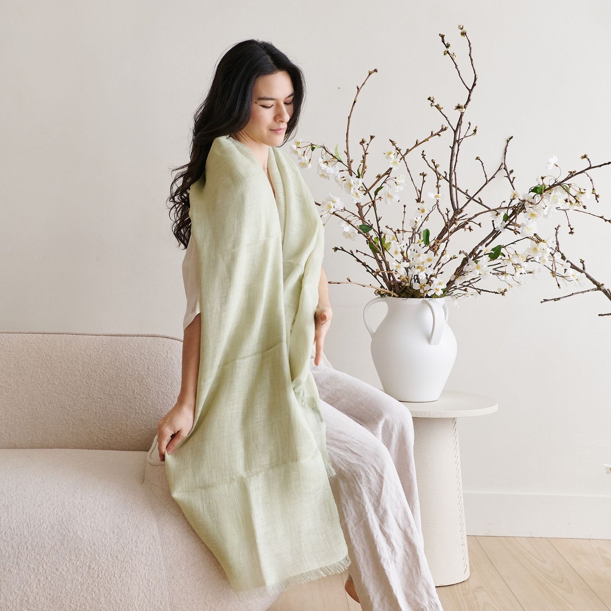 Soya Pastel Lime Green Hand Woven Soft Linen Scarf draped elegantly in a stylish indoor setting.