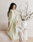 Soya Pastel Lime Green Hand Woven Soft Linen Scarf draped elegantly in a stylish indoor setting.