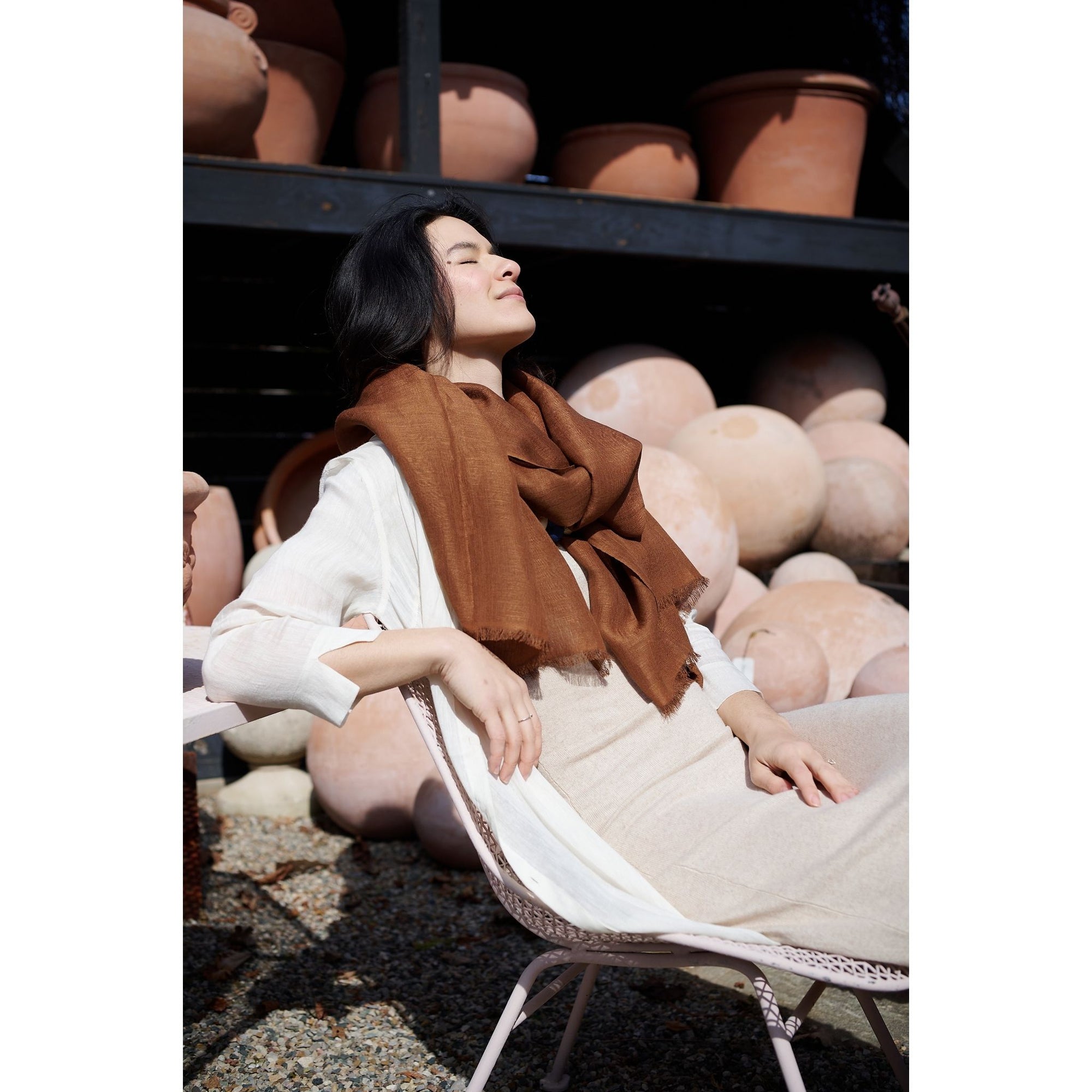 Coco Brown Hand Woven Linen Silk Blend Scarf styled with a casual outfit in a serene outdoor setting.