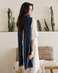 Midnight Navy Blue Hand Woven Linen Silk Blend Scarf elegantly draped on a woman, showcasing its translucent appeal.