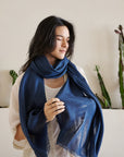 Midnight Navy Blue Hand Woven Linen Silk Blend Scarf elegantly draped over a model, showcasing its translucent appeal.