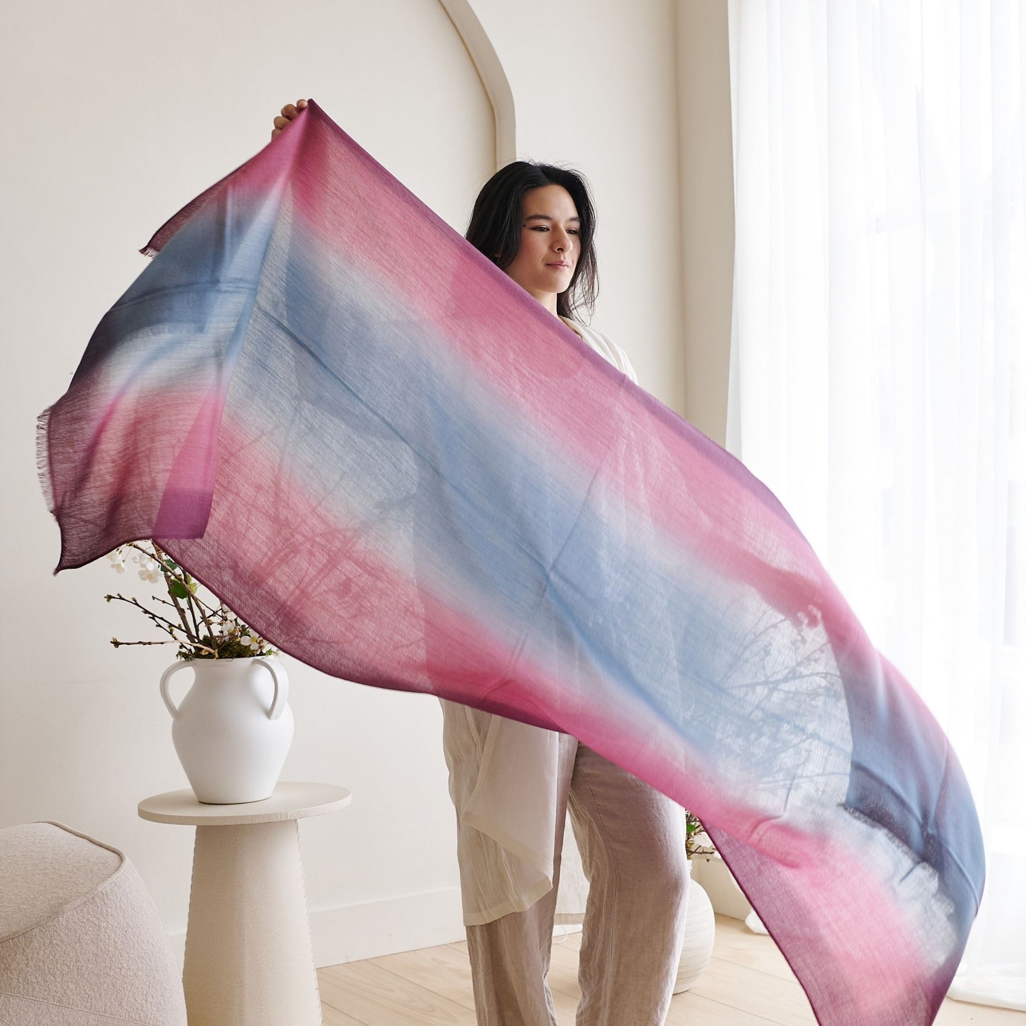Iris Haze Blue Pink Cashmere Merino Handloom Scarf held by a model, showcasing its unique hand-dyed colors.