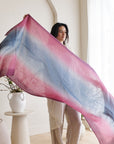 Iris Haze Blue Pink Cashmere Merino Handloom Scarf held by a model, showcasing its unique hand-dyed colors.