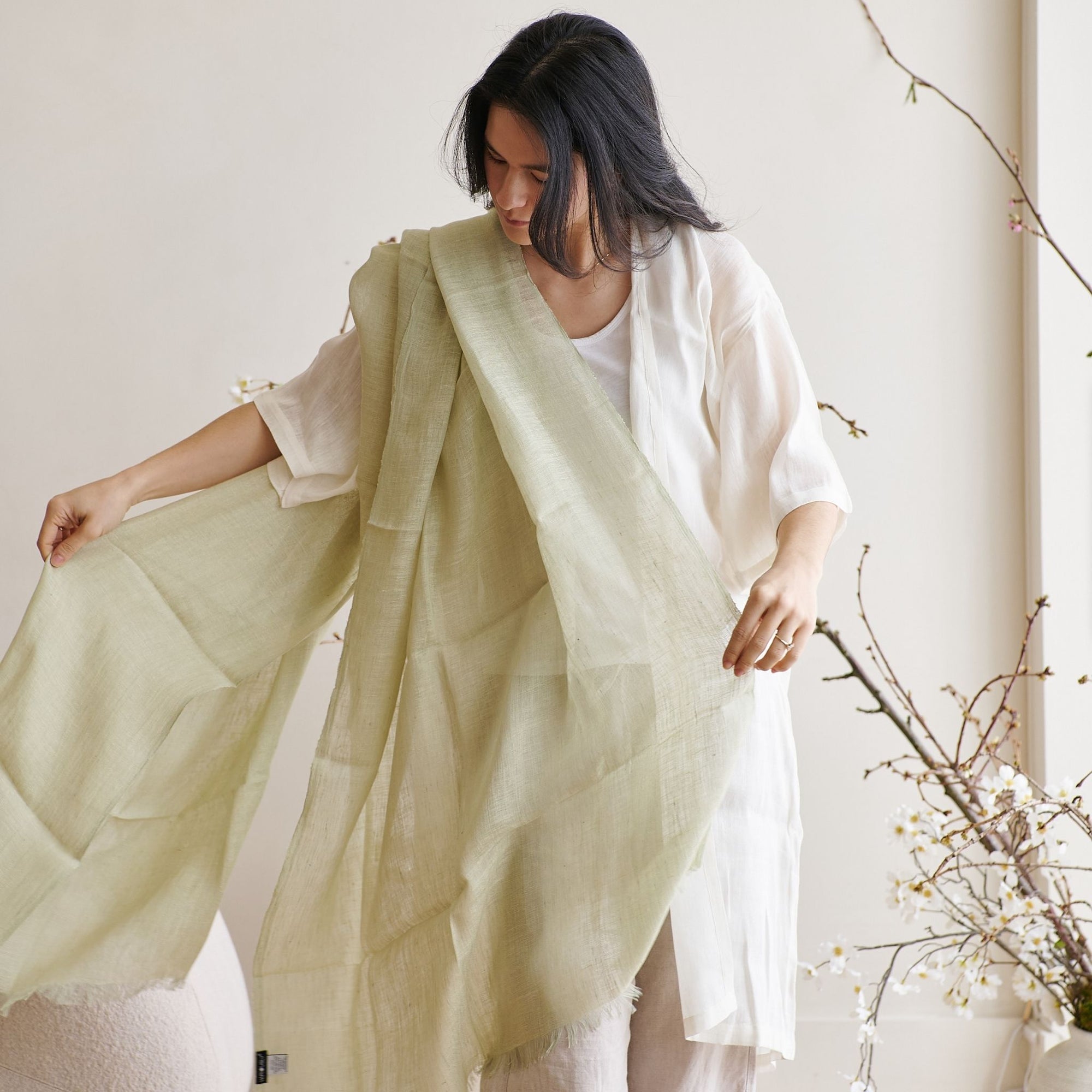 Soya Pastel Lime Green Hand Woven Soft Linen Scarf elegantly styled by a model in soft, natural light.