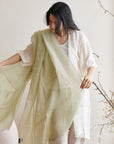 Soya Pastel Lime Green Hand Woven Soft Linen Scarf elegantly styled by a model in soft, natural light.