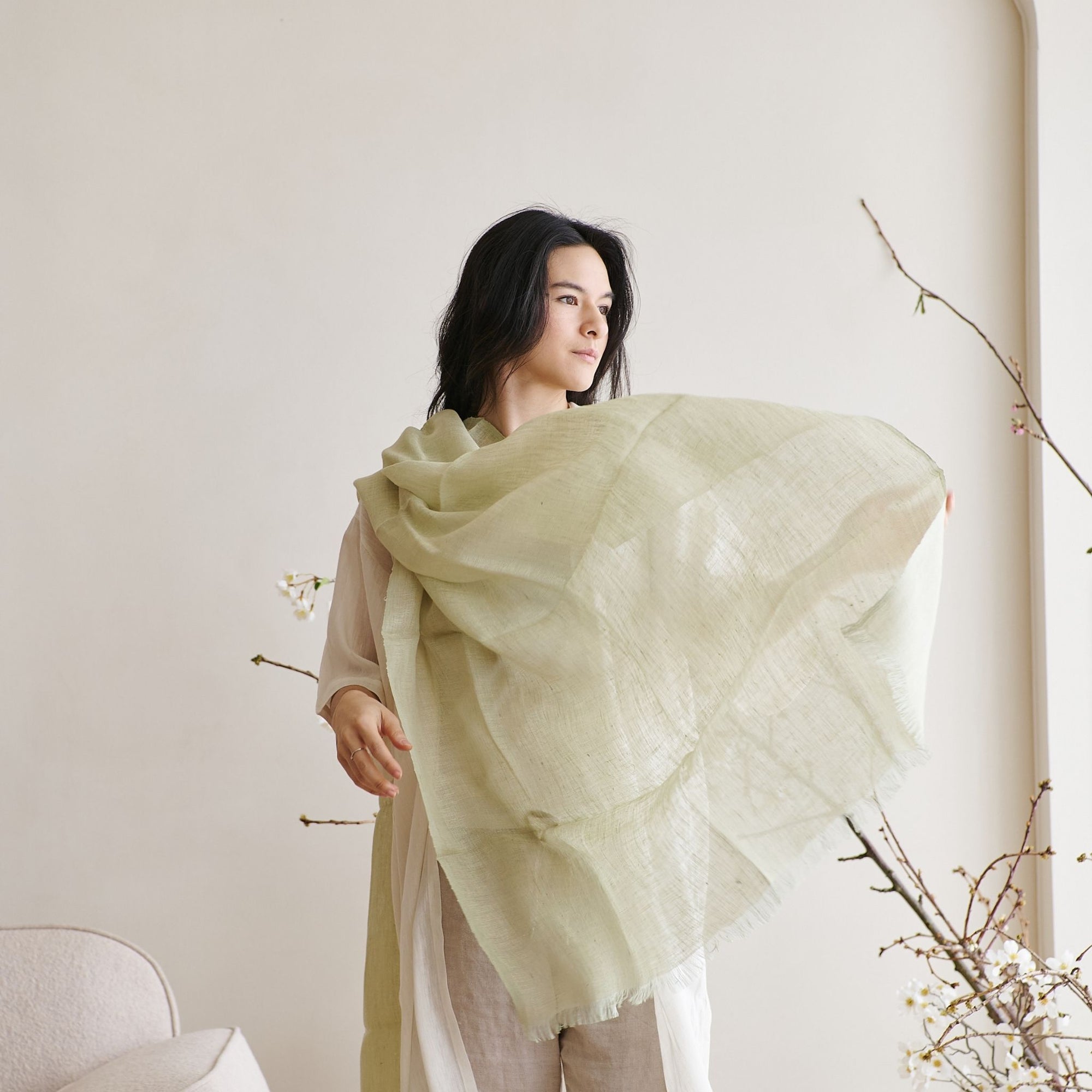 Soya Pastel Lime Green Hand Woven Soft Linen Scarf draped elegantly on a woman showcasing its translucent appeal.