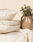 Dahli Coral Multicolor Artisanal Hand Embroidered Pillow Cover displayed with a decorative vase.