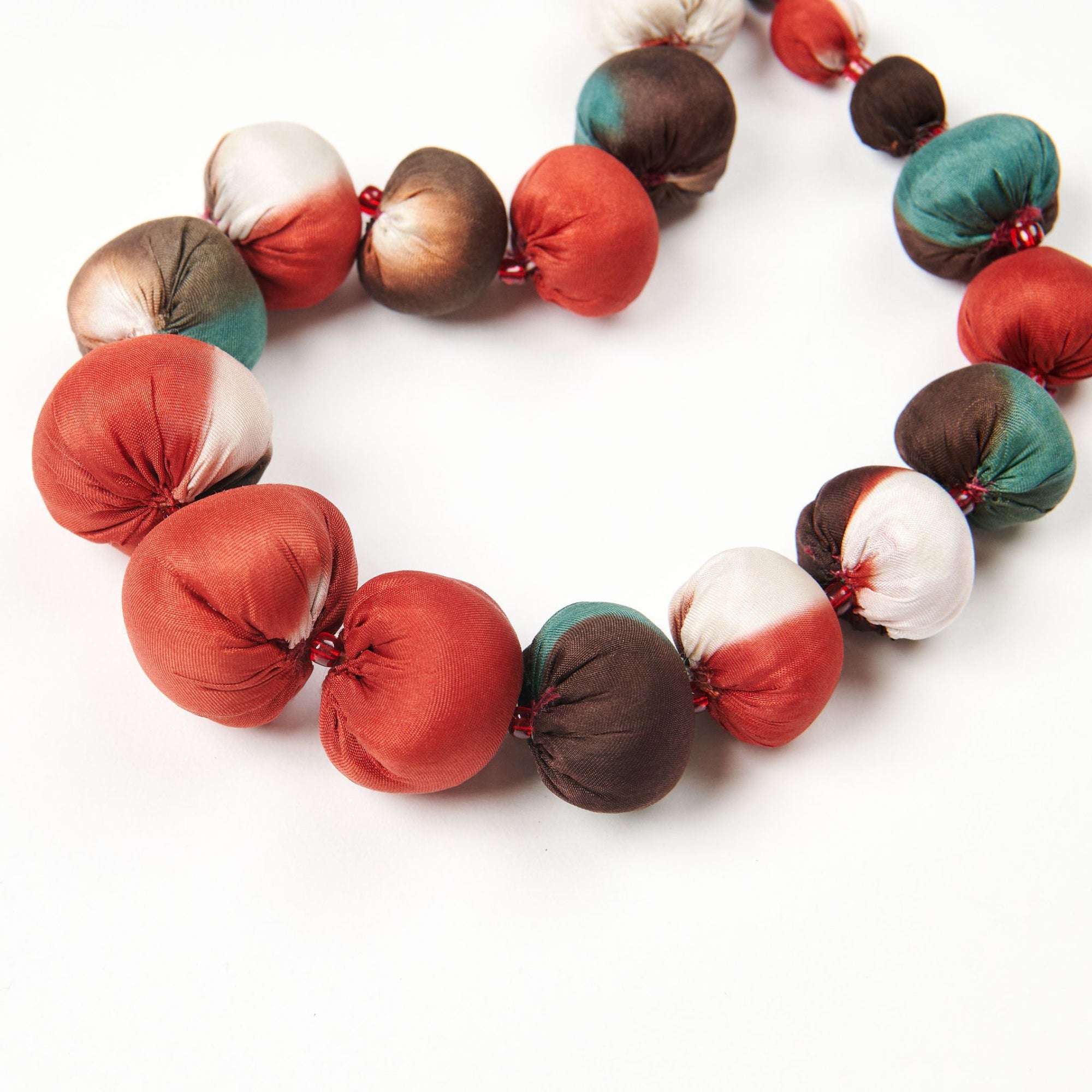 Mihika Red Silk Beaded Necklace Modern Artisanal close-up of handcrafted silk beads in vibrant colors.