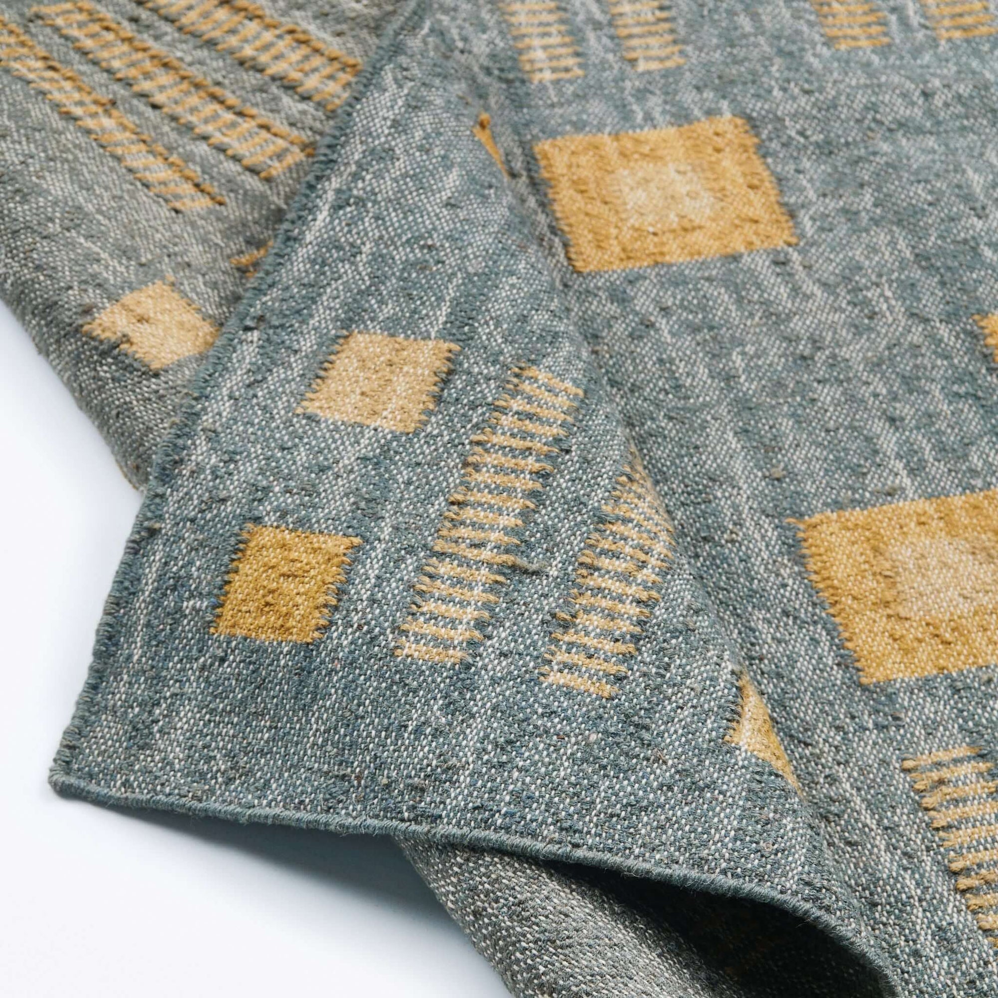 Close-up of the Ash Blue Gray Jute Handwoven Geometric Pattern Rug showcasing detailed patterns and textures.