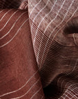 Auro Cinnabar Handwoven Earthy Rust Maroon Linen Scarf displaying rich earthy tones and delicate texture in elegant patterns.