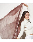 Woman wearing Auro Cinnabar Handwoven Earthy Rust Maroon Linen Scarf, showcasing its unique texture and pattern.