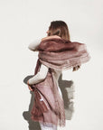Auro Cinnabar Handwoven Earthy Rust Maroon Linen Scarf elegantly draped on a model against a white wall.