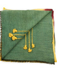 Avocado Green Multi Color Warm Hues Hand Woven Hand Knotted Textured Merino Throw with tassels and textured detail.