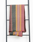 Barque Clay Modern Artisan Striped Soft Merino Handwoven Scarf hanging on a ladder display.