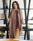 Barque Clay Modern Artisan Striped Soft Merino Handwoven Scarf worn by a model in a stylish indoor setting.