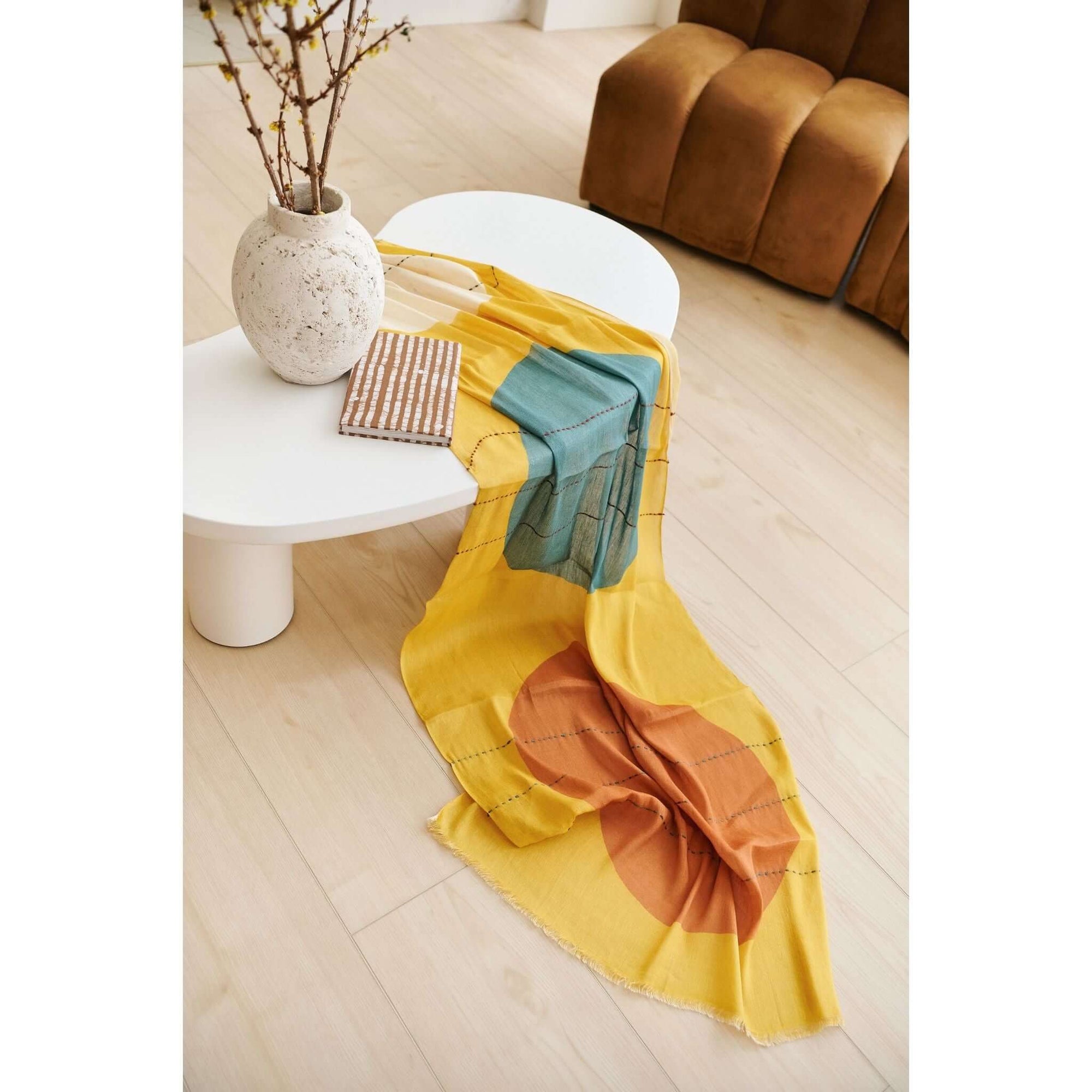 Cirq Sun Yellow Green Circle Pattern Hand Embroidered Linen Silk Handloom Scarf draped elegantly on a minimalist table.