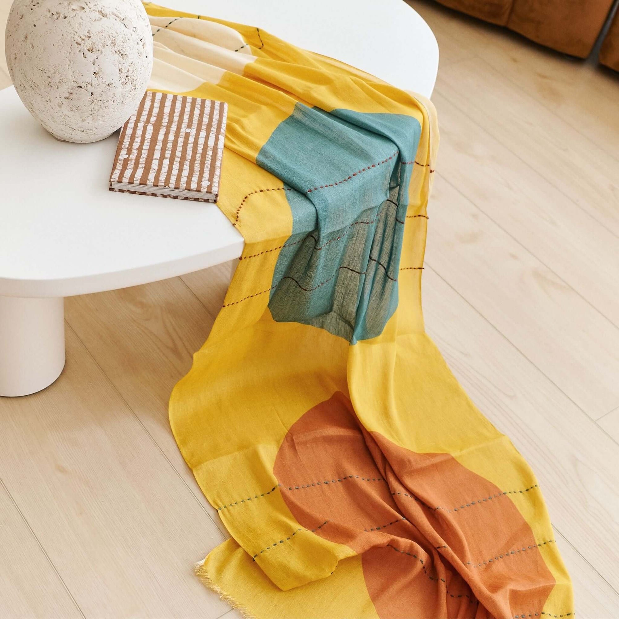 Cirq Sun Yellow Green Circle Pattern Hand Embroidered  Linen Silk Handloom Scarf draped over a table with decorative items.