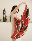 Fawn Square Silk Artisanal Scarf In Multicolor Hand Crafted Shibori Print being held by a woman against a neutral background.