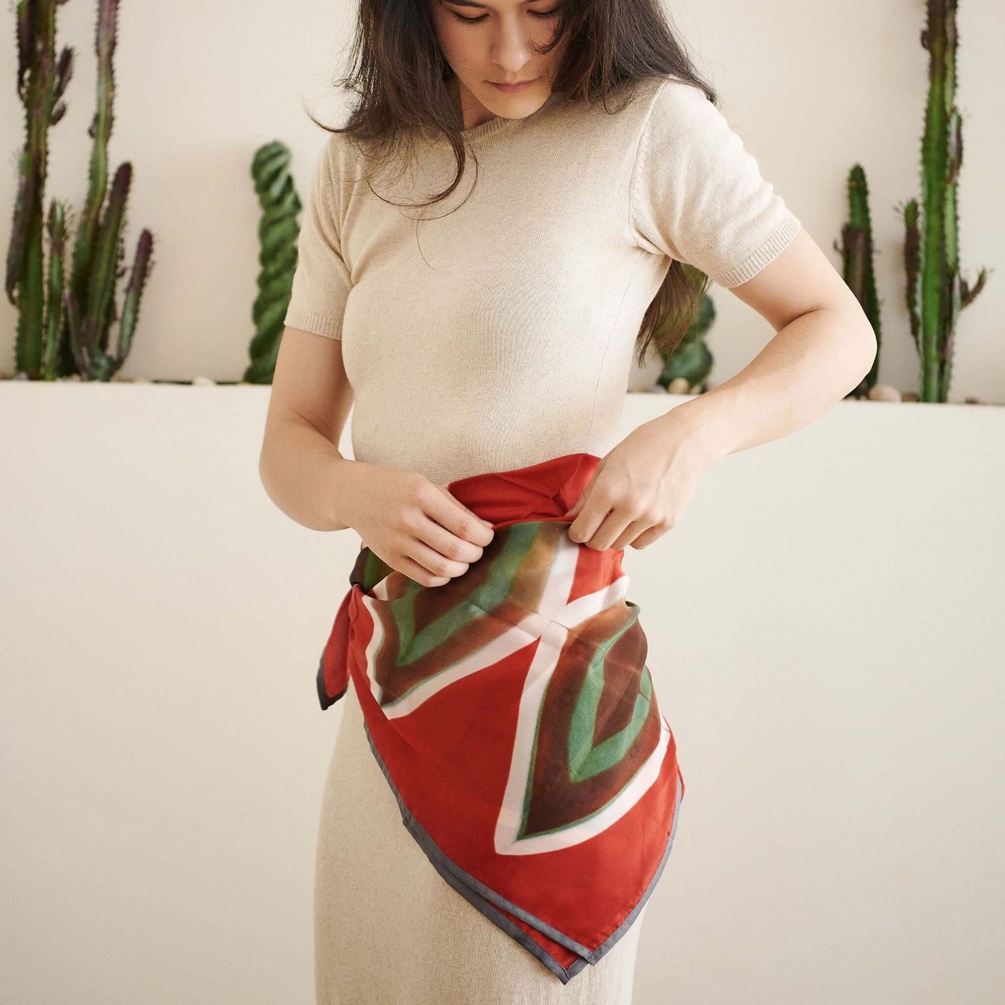 Fawn Square Silk Artisanal Scarf In Multicolor Hand Crafted Shibori Print styled around the waist by a model.