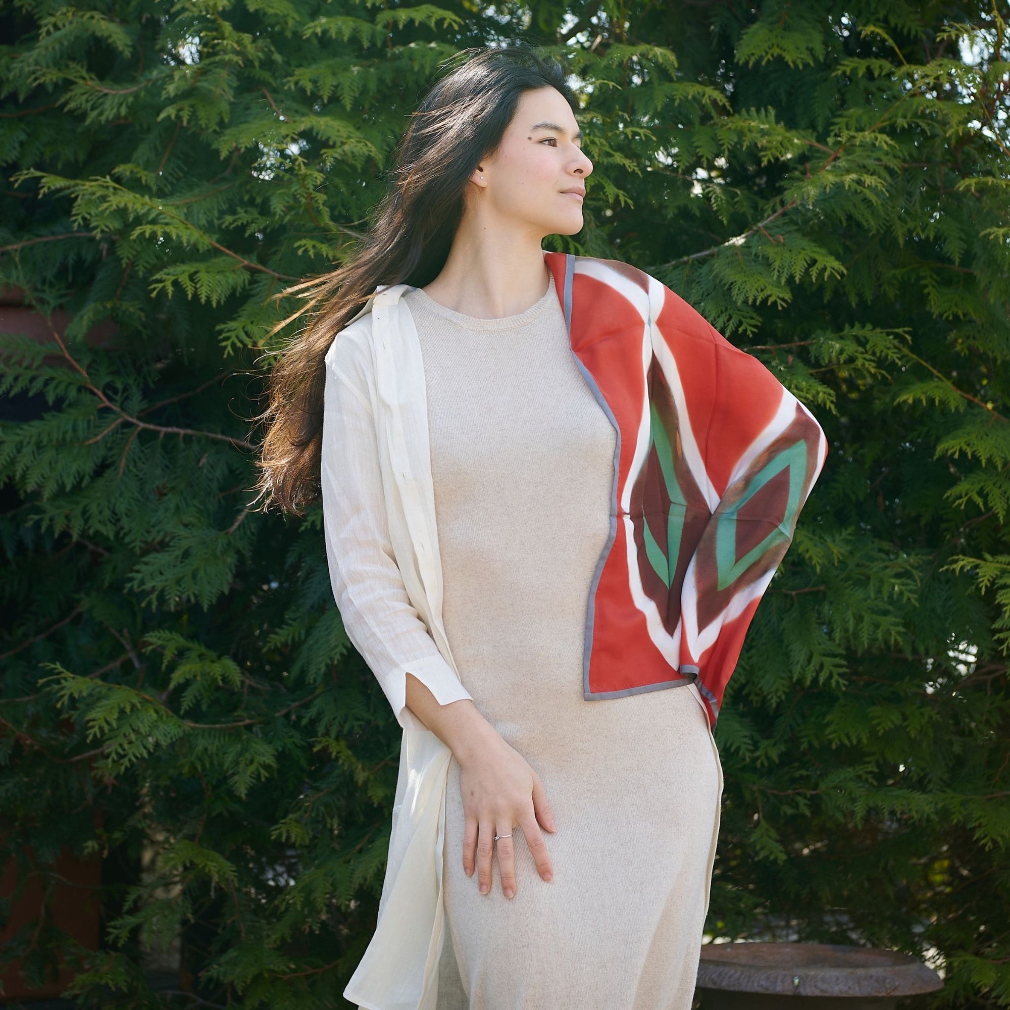 Fawn Square Silk Artisanal Scarf In Multicolor Hand Crafted Shibori Print draped elegantly on a model outside.