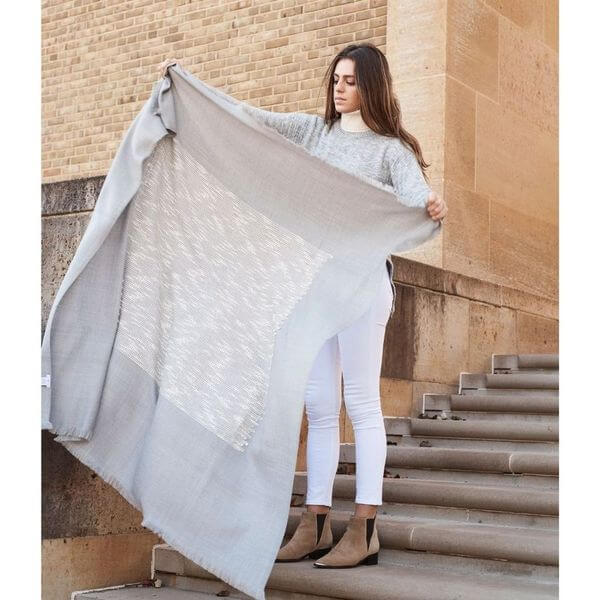 Model showcasing the Flo Gray Textured Handloom Merino Throw, highlighting its luxurious design and craftsmanship.