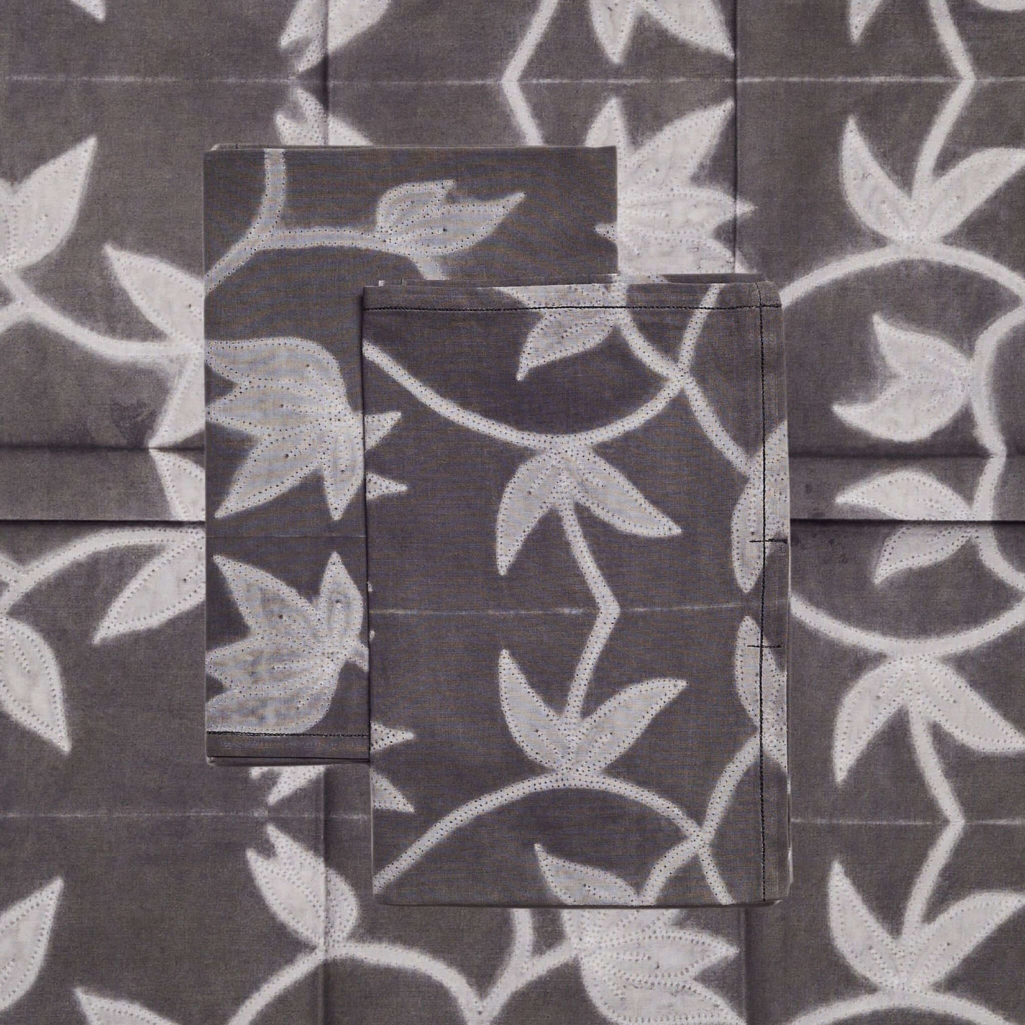 Folio Black Handcrafted Shibori Print Cotton Table Napkins ( set of 4 ) featuring unique white floral designs on dark fabric.