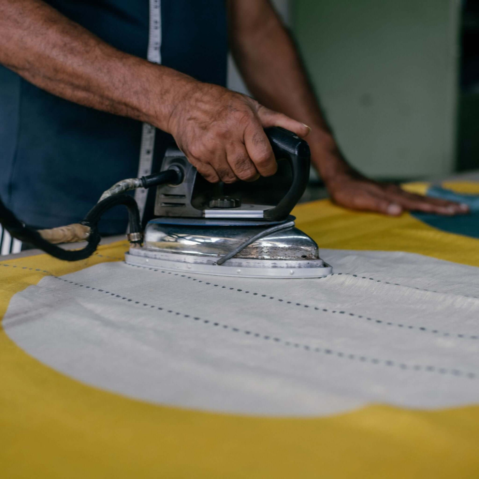 Cirq Sun Yellow Green Circle Pattern Hand Embroidered  Linen Silk Handloom Scarf being ironed with a vintage iron.