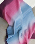 Iris Haze Blue Pink Cashmere Merino Handloom Scarf draped elegantly on a table, showcasing soft blended colors.