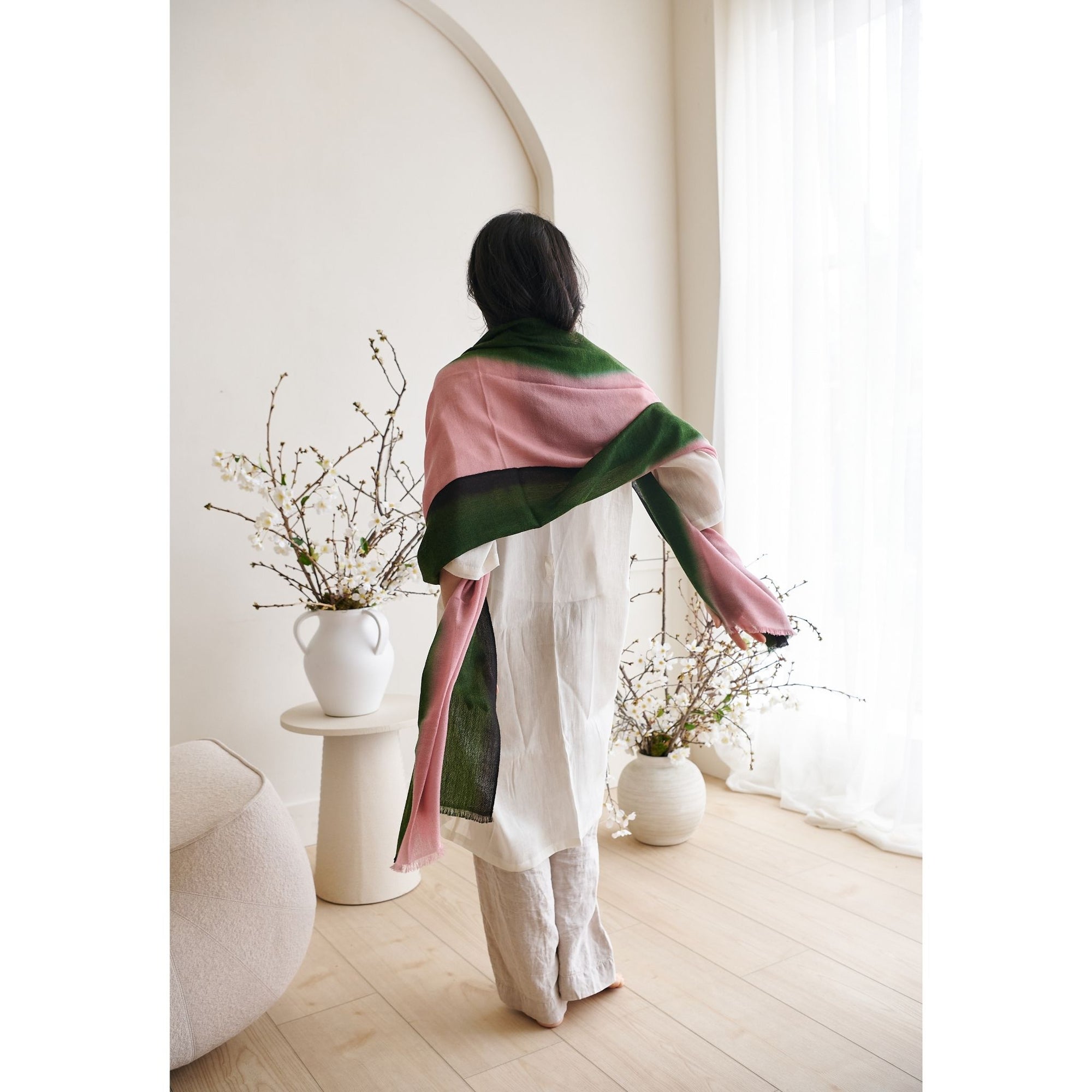 Iris Kiwi Green Pink Cashmere Merino Handwoven Scarf worn elegantly by a model in a minimalist indoor setting.