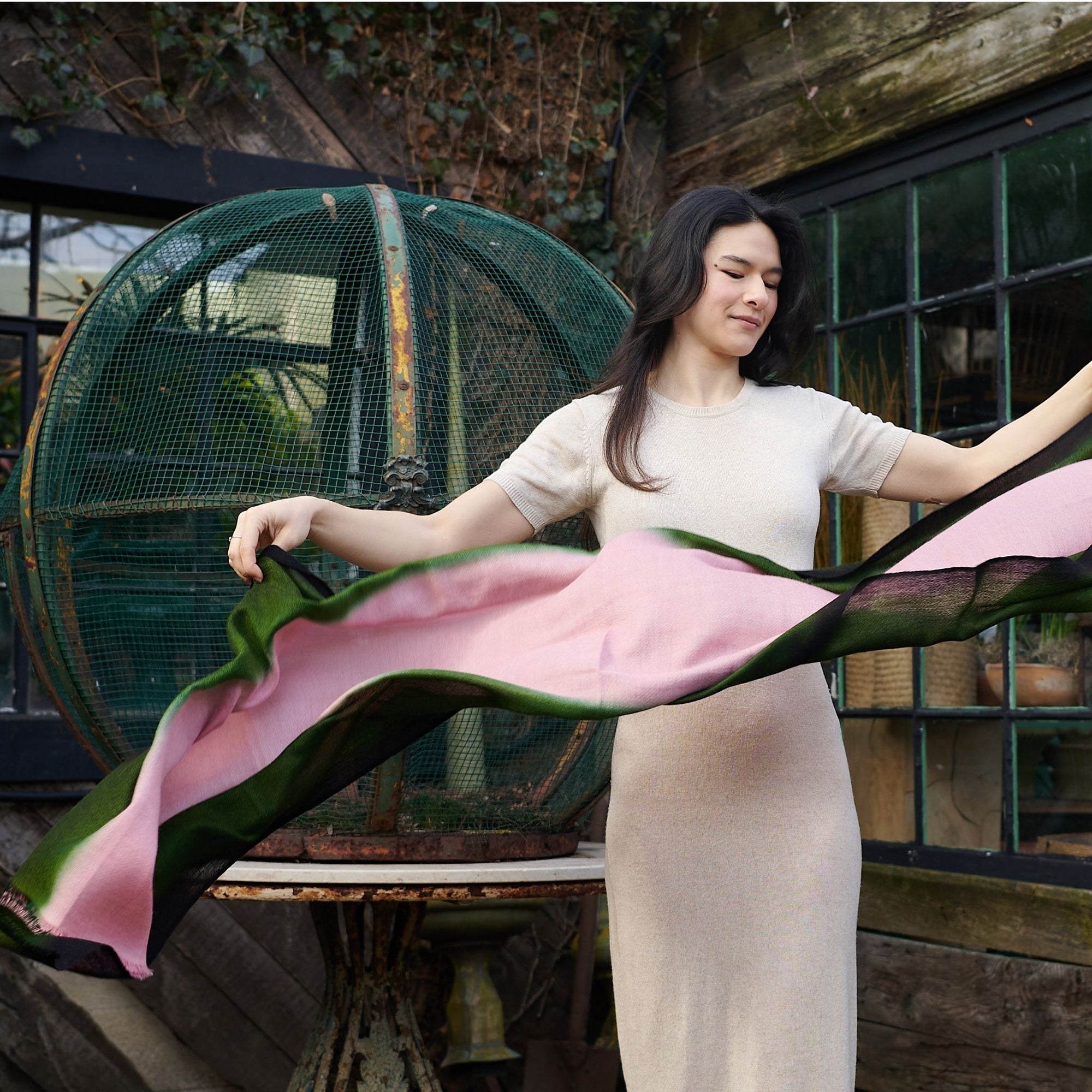 Iris Kiwi Green Pink Cashmere Merino Handwoven Scarf being elegantly displayed outdoors.