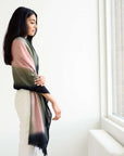 Iris Kiwi Green Pink Cashmere Merino Handwoven Scarf draped elegantly by a model, showcasing its unique colors and craftsmanship.