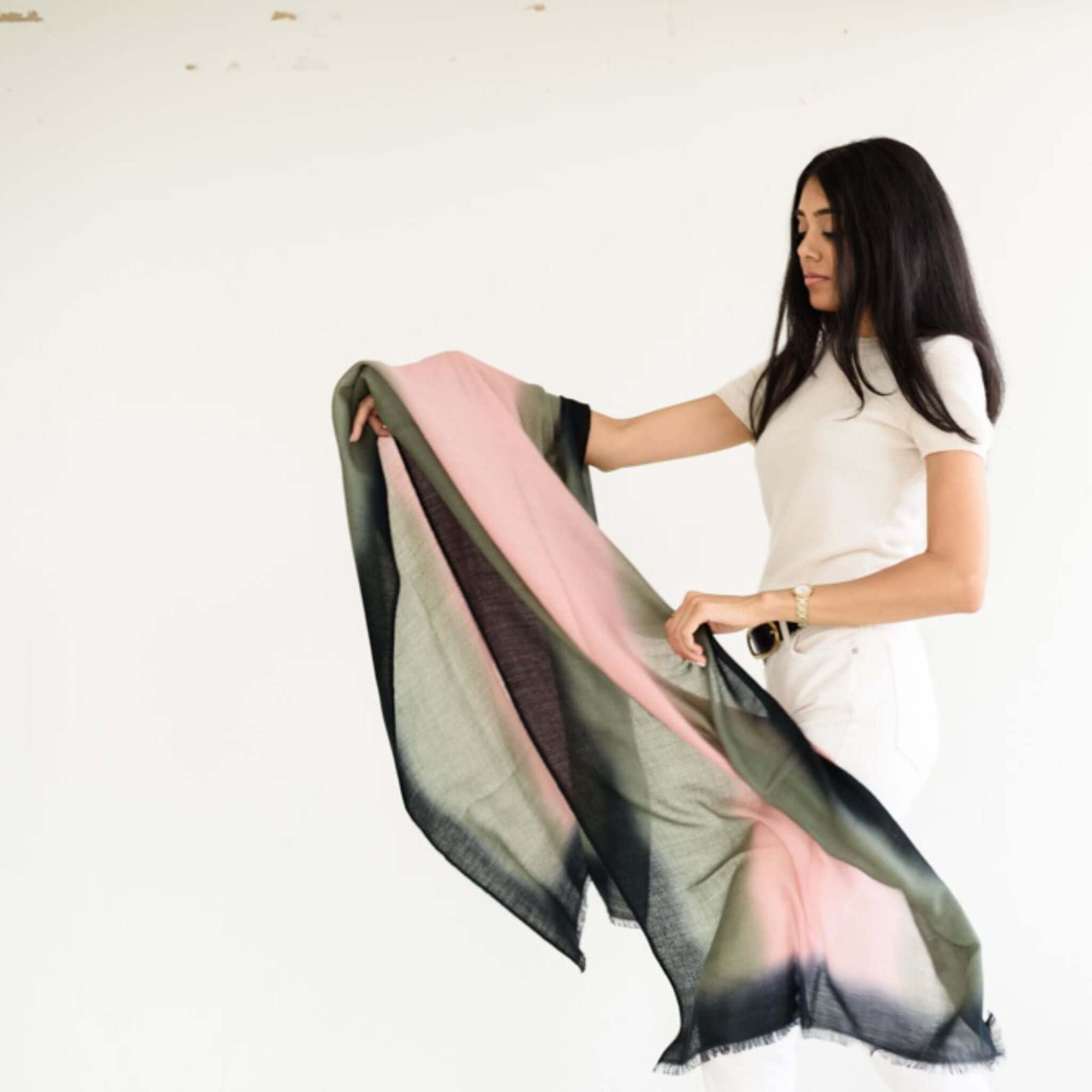 Model holding Iris Kiwi Green Pink Cashmere Merino Handwoven Scarf showcasing its unique colors and craftsmanship.