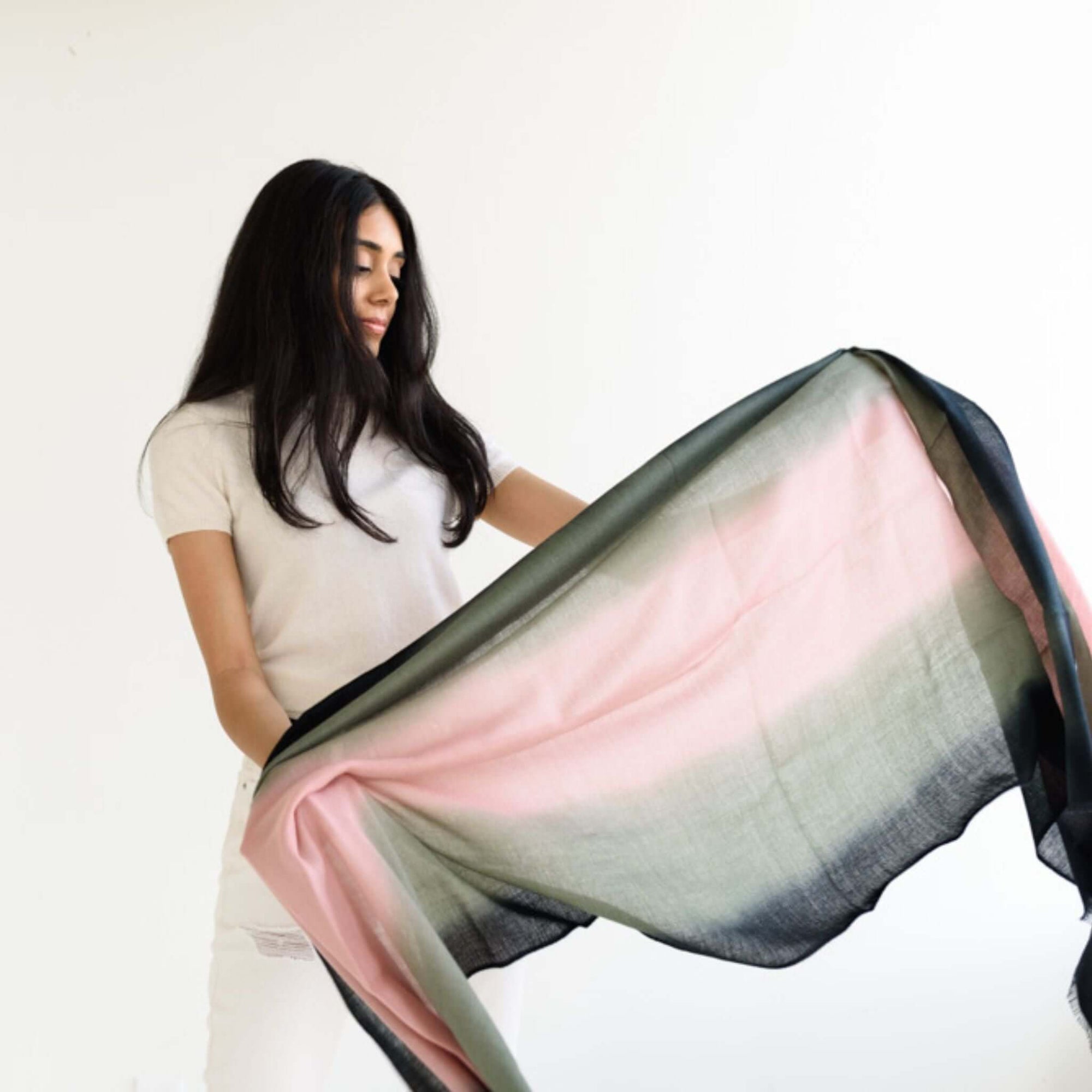 Iris Kiwi Green Pink Cashmere Merino Handwoven Scarf held by a model, showcasing its unique blend of colors and luxury.