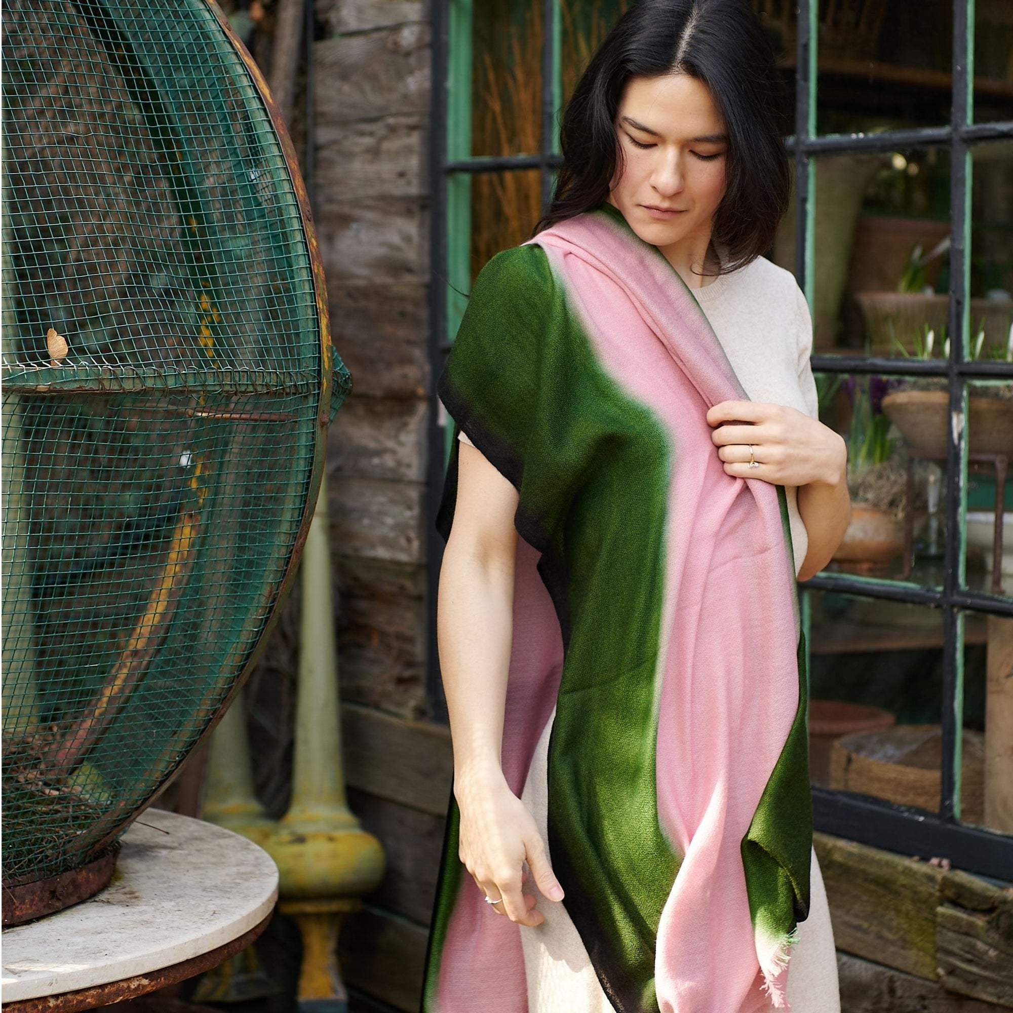 Iris Kiwi Green Pink Cashmere Merino Handwoven Scarf displayed on a woman, showcasing its unique colors and craftsmanship.