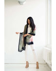 Iris Kiwi Green Pink Cashmere Merino Handwoven Scarf showcased by model in light-filled space.