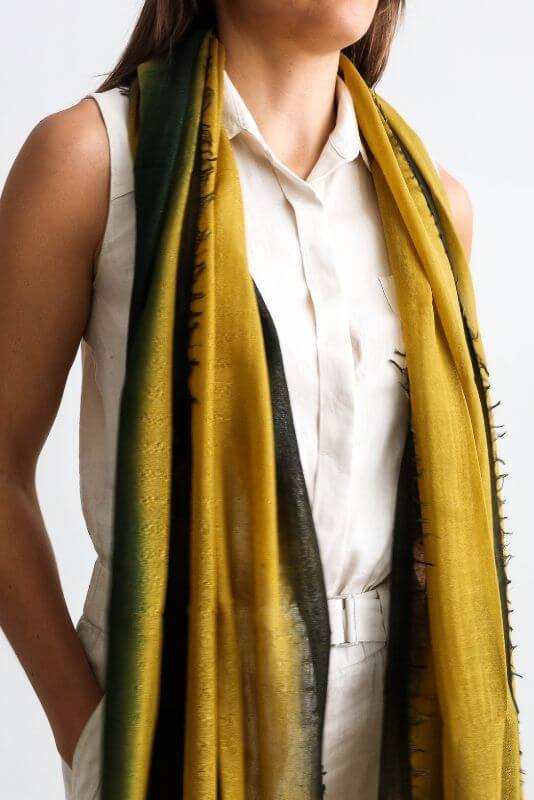 Iris Topaz Yellow Olive Green Cashmere Merino Soft Handwoven Modern Artisanal Scarf worn by a model against a light background.