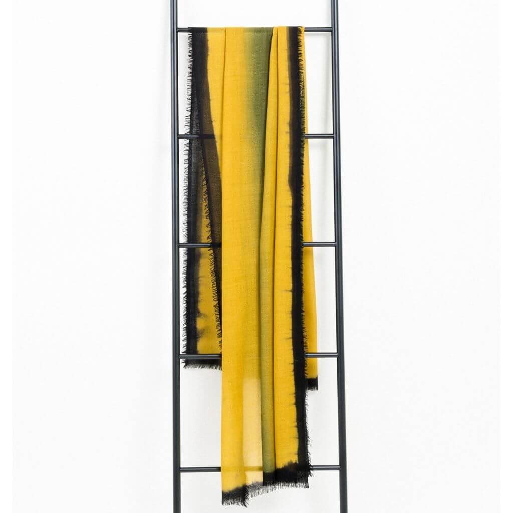 Iris Topaz Yellow Olive Green Cashmere Merino Soft Handwoven Modern Artisanal Scarf displayed on a ladder.