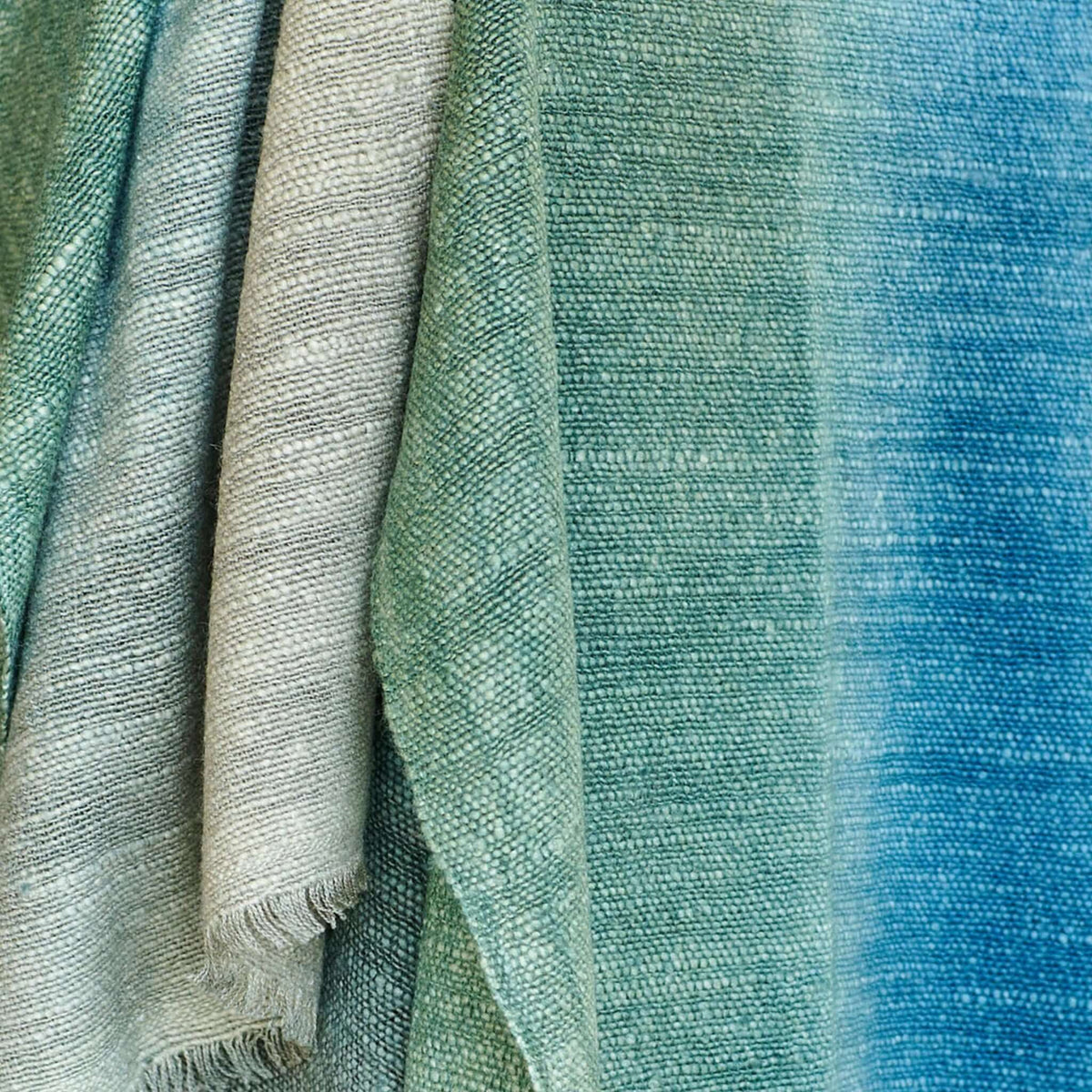 Lake Moss Handwoven Merino Throw Blanket in serene blue green hues, showcasing its artisanal craftsmanship.