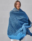 Woman draped in Macaroon Midnight Dark Blue Textured Merino Handloom Throw showcasing its luxurious texture.