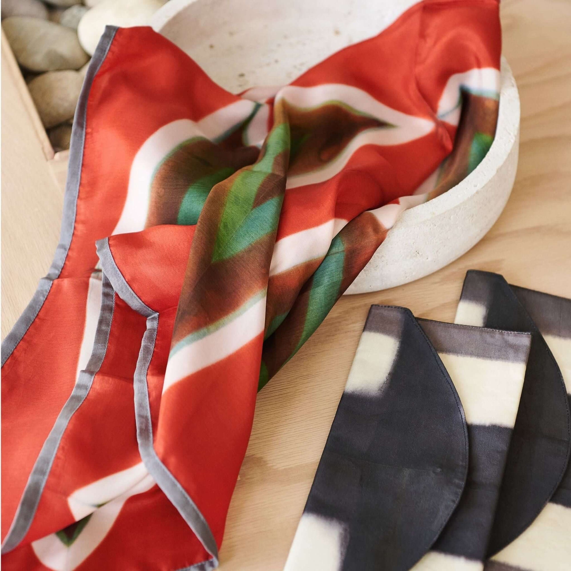 Melo Black Handcrafted Silk Travel Pouch Organizer with vibrant silk fabric in a decorative bowl.