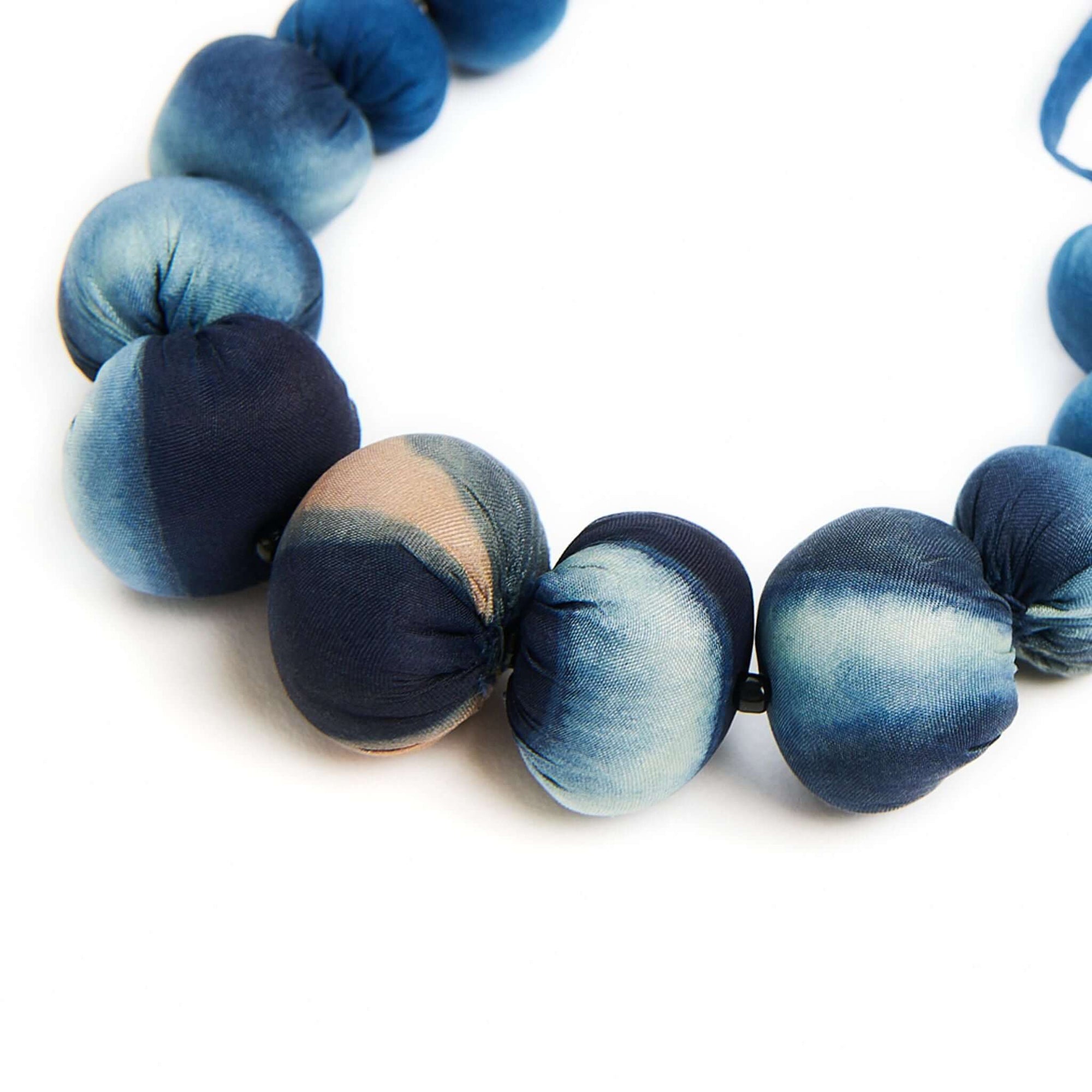 Mihika silk beaded necklace featuring handcrafted silk beads in shades of blue and natural variations.