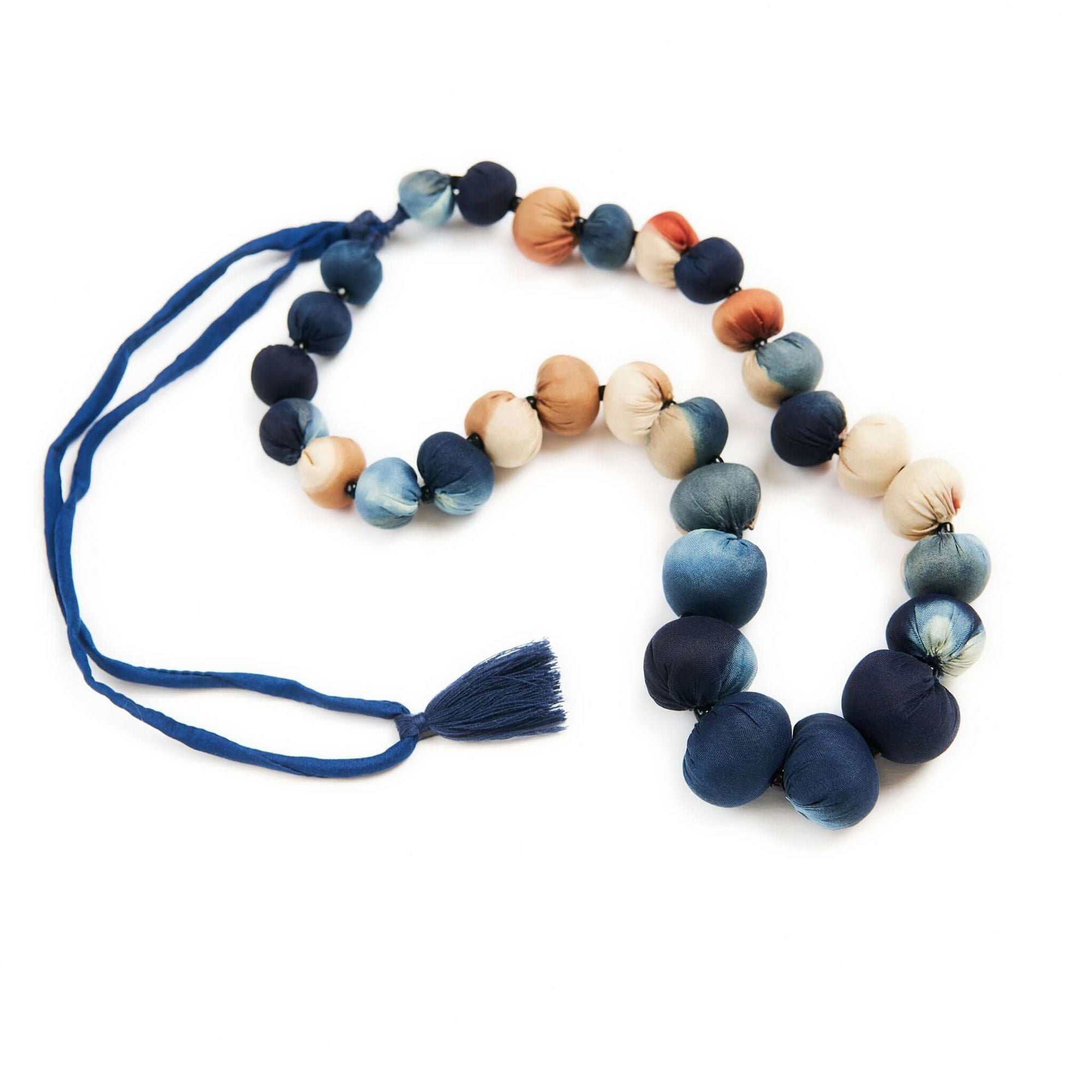 Mihika silk beaded necklace modern artisanal design featuring handcrafted silk beads in various shades of blue and peach.