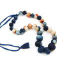 Mihika silk beaded necklace modern artisanal design featuring handcrafted silk beads in various shades of blue and peach.