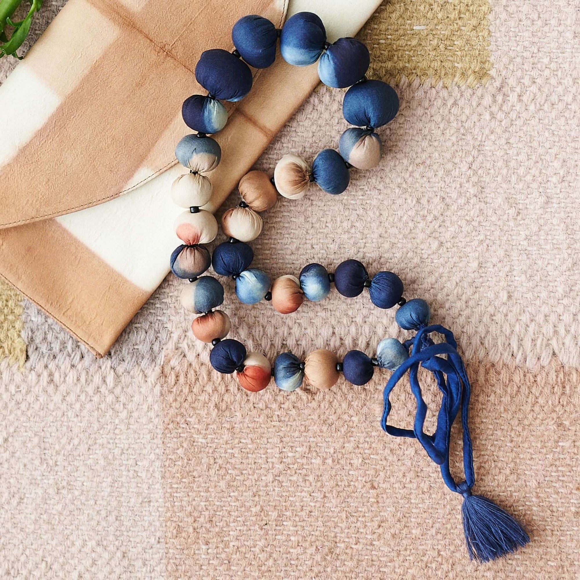 Mihika silk beaded necklace modern artisanal design with handcrafted silk beads in shades of blue and peach.