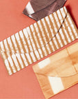 Oak Brown Stripes Cotton Wax Block Printed Envelope Pouch shown on a flat background with other pouches.