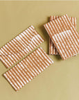 Oak Brown Stripes Cotton Wax Block Printed Envelope Pouch on a beige background.