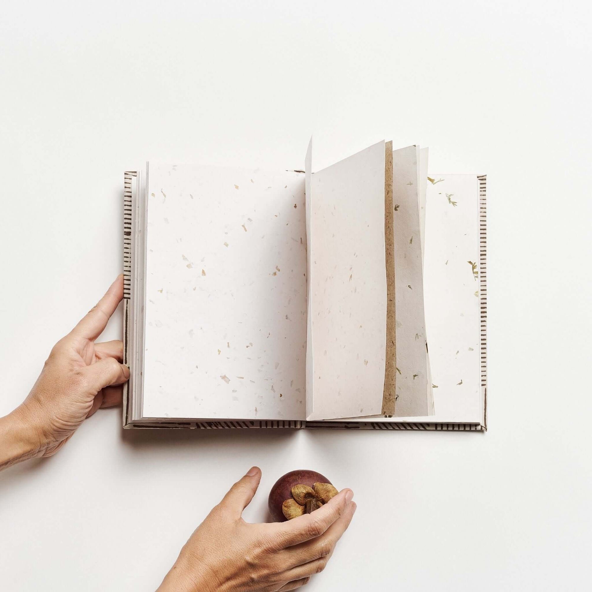 Open pages of Bistre Black Zero Waste Handmade Artisanal Journal showing natural paper texture.
