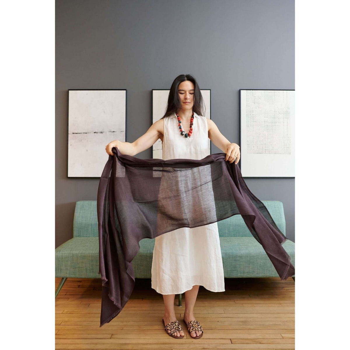 Model displaying the Resin Dark Brown Hand Woven Soft Linen Silk Scarf in a stylish room.
